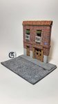 DIORAMA OF STREET WITH BUILDING.